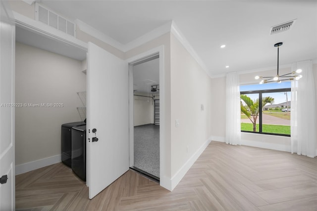 corridor featuring baseboards, visible vents, washer and dryer, and ornamental molding