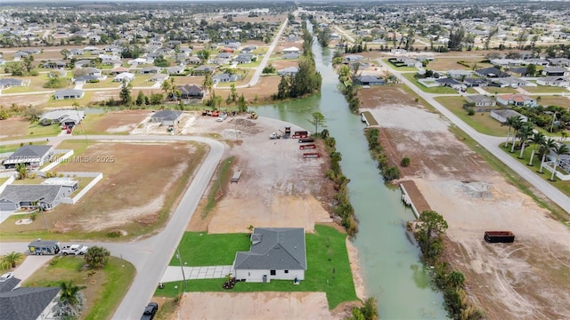 drone / aerial view featuring a residential view and a water view