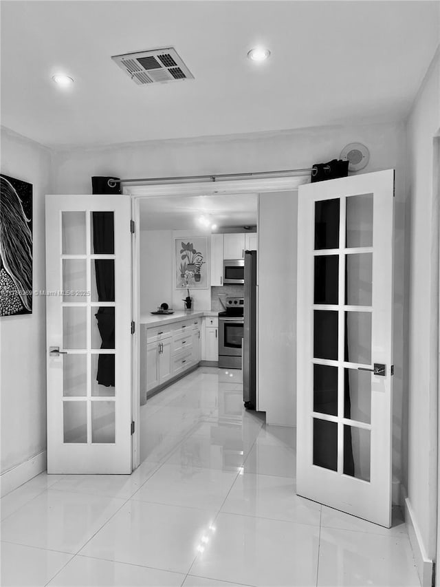 kitchen featuring recessed lighting, visible vents, white cabinetry, light countertops, and appliances with stainless steel finishes