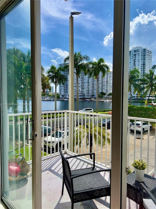 balcony with a view of city and a water view