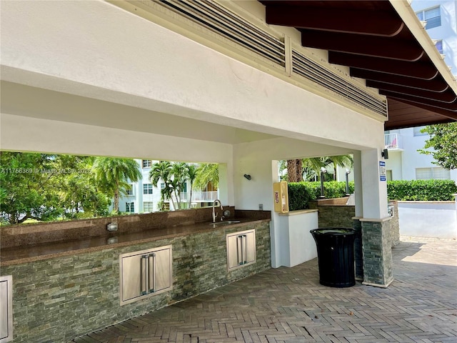 view of patio / terrace with an outdoor kitchen and a sink