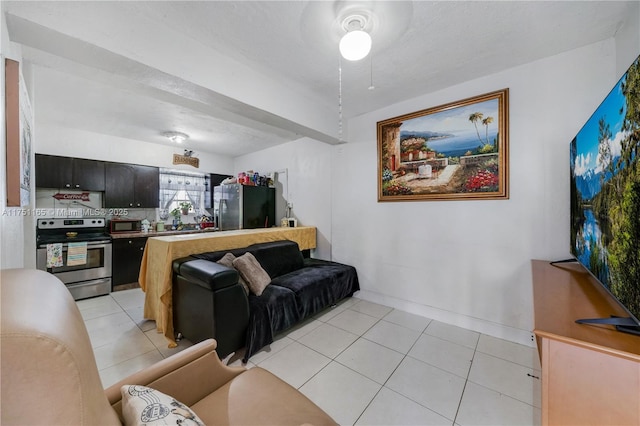 living room featuring light tile patterned floors and baseboards