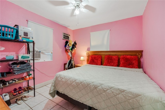 tiled bedroom featuring a ceiling fan, cooling unit, a wall unit AC, and baseboards