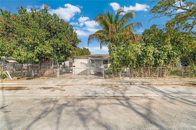 view of front of house with a fenced front yard and a gate