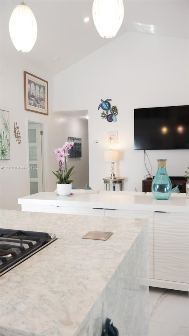 213 Florida Ave, Coral Gables, FL 33133 - kitchen with vaulted ceiling, light countertops, and hanging light fixtures