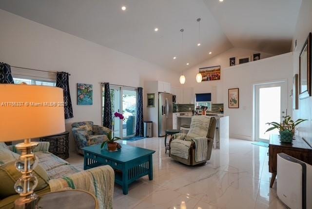 living room with high vaulted ceiling, marble finish floor, recessed lighting, and plenty of natural light