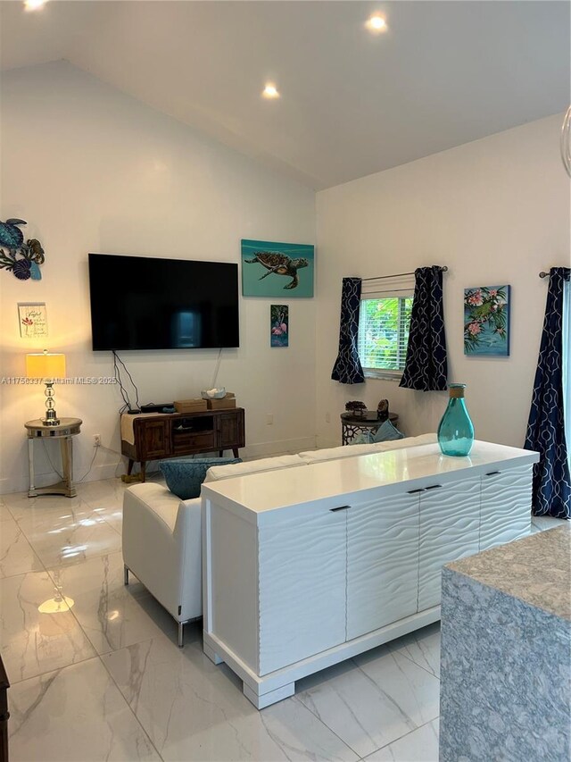 213 Florida Ave, Coral Gables, FL 33133 - living area featuring light marble finish flooring, lofted ceiling, and recessed lighting