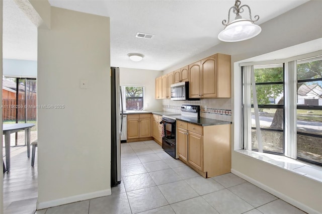 kitchen featuring a textured ceiling, visible vents, appliances with stainless steel finishes, light brown cabinetry, and tasteful backsplash