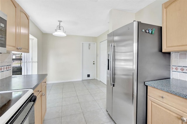 kitchen featuring light tile patterned floors, dark countertops, appliances with stainless steel finishes, light brown cabinetry, and backsplash