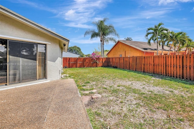 view of yard featuring a patio area and a fenced backyard