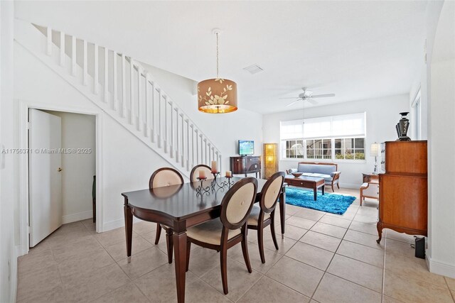 dining space with baseboards, light tile patterned floors, and ceiling fan