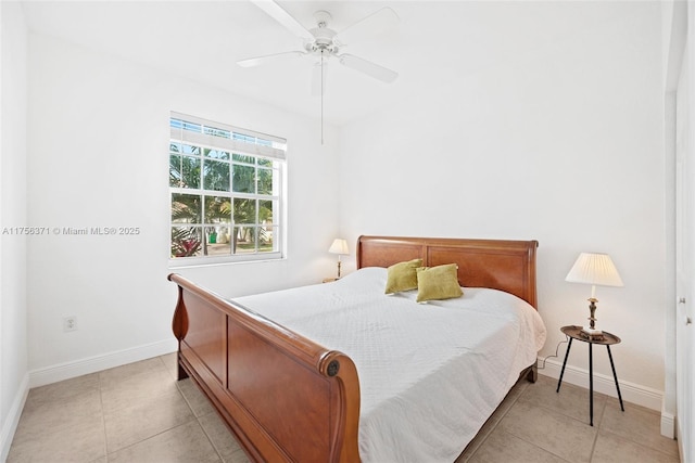 bedroom featuring light tile patterned floors, a ceiling fan, and baseboards