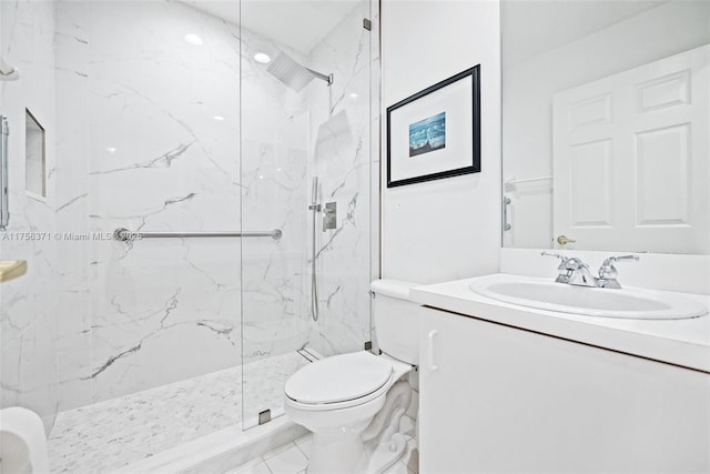 bathroom featuring a marble finish shower, toilet, and vanity