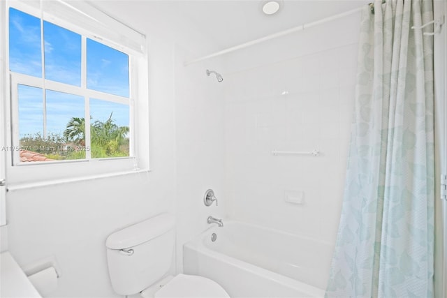 bathroom featuring toilet and shower / tub combo with curtain