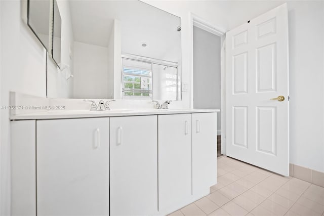 kitchen featuring white cabinetry, light tile patterned flooring, light countertops, and a sink