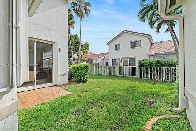 view of yard featuring central AC and fence