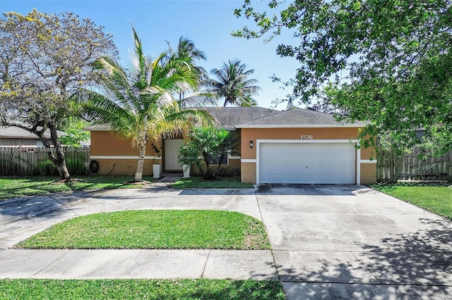 view of front of home with driveway, an attached garage, fence, and stucco siding