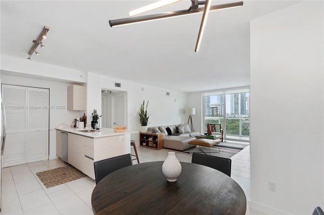 dining space featuring light tile patterned floors, visible vents, and rail lighting