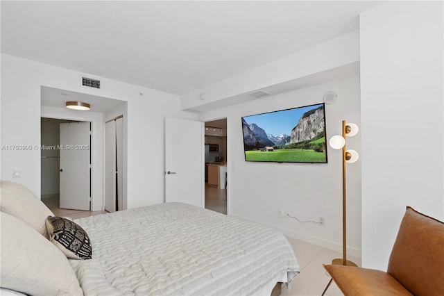 bedroom with a closet, visible vents, and baseboards