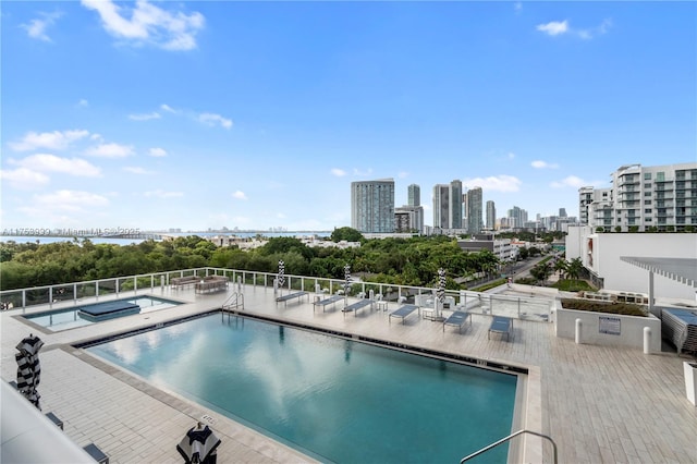 community pool featuring a view of city and a patio area