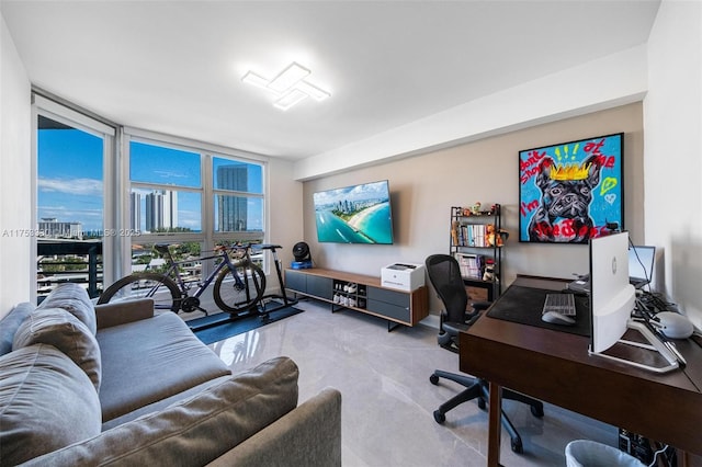 home office featuring finished concrete flooring and expansive windows