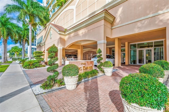 property entrance with french doors and stucco siding