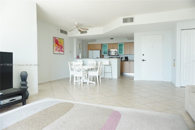 dining room featuring light tile patterned floors, baseboards, visible vents, and a ceiling fan