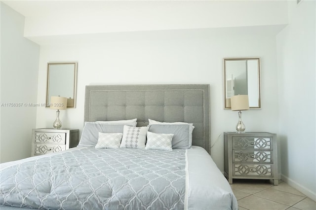 bedroom featuring tile patterned flooring and baseboards