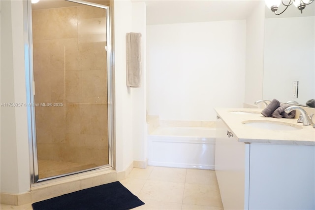 bathroom with a bath, a stall shower, tile patterned flooring, and a sink