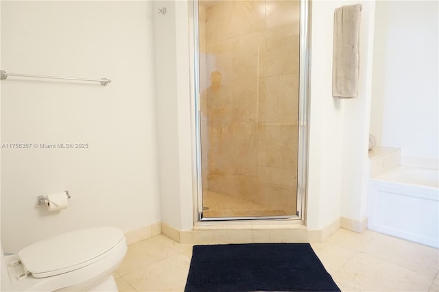 bathroom with a stall shower, baseboards, toilet, tile patterned flooring, and a bath