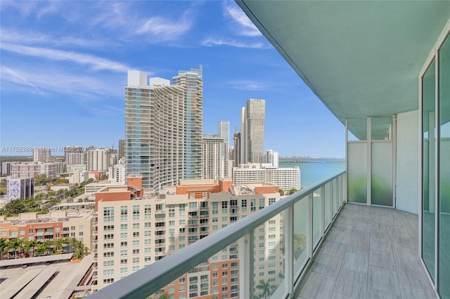 balcony with a water view and a city view