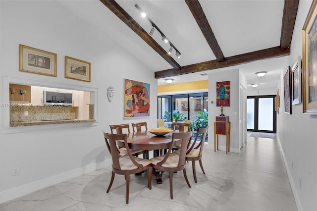 dining room featuring lofted ceiling with beams, baseboards, marble finish floor, and track lighting