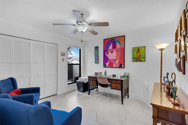 office area featuring baseboards, marble finish floor, a textured ceiling, and a ceiling fan