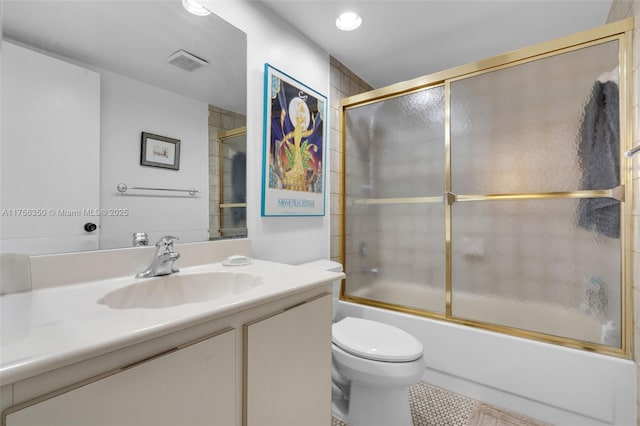 bathroom with visible vents, toilet, tile patterned flooring, enclosed tub / shower combo, and vanity