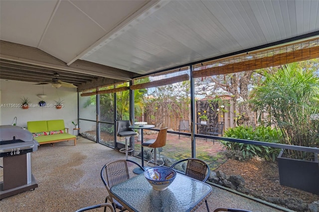 sunroom featuring ceiling fan