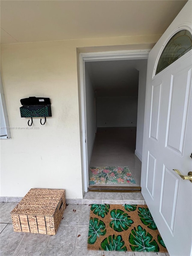 view of exterior entry with stucco siding