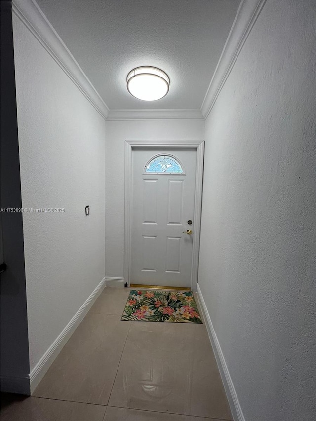 entryway with a textured wall, crown molding, a textured ceiling, and baseboards