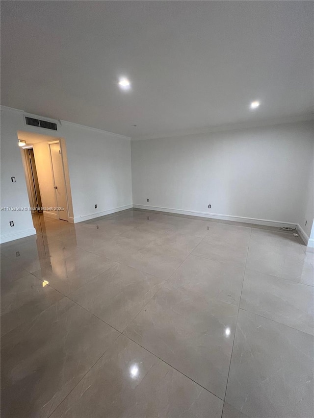 spare room featuring baseboards, visible vents, and recessed lighting