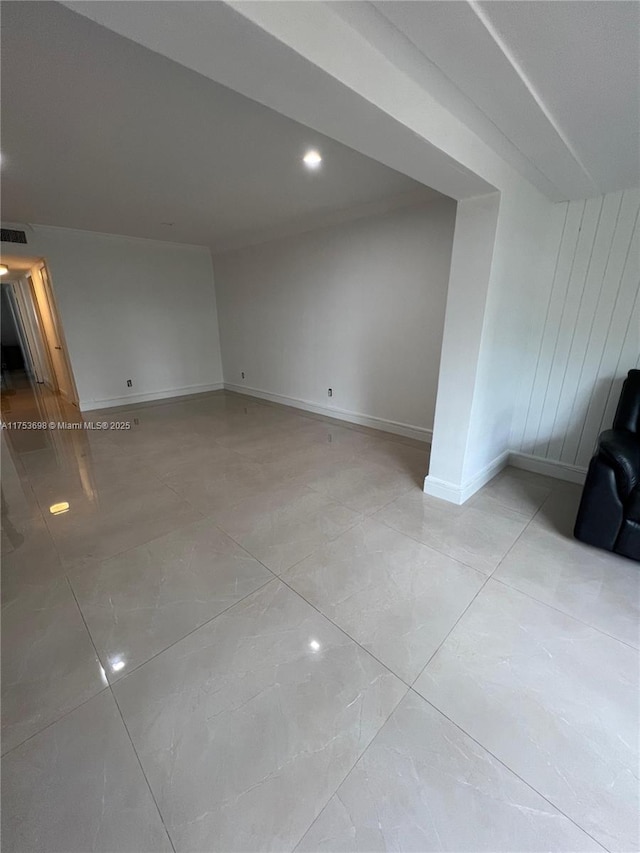 additional living space with light tile patterned floors, baseboards, and visible vents