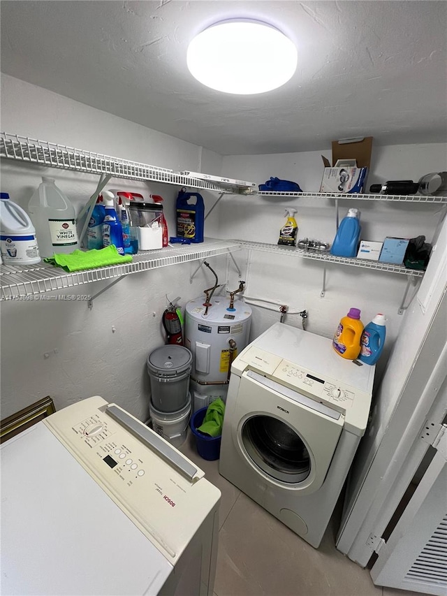 laundry area featuring a textured ceiling, laundry area, and washing machine and dryer