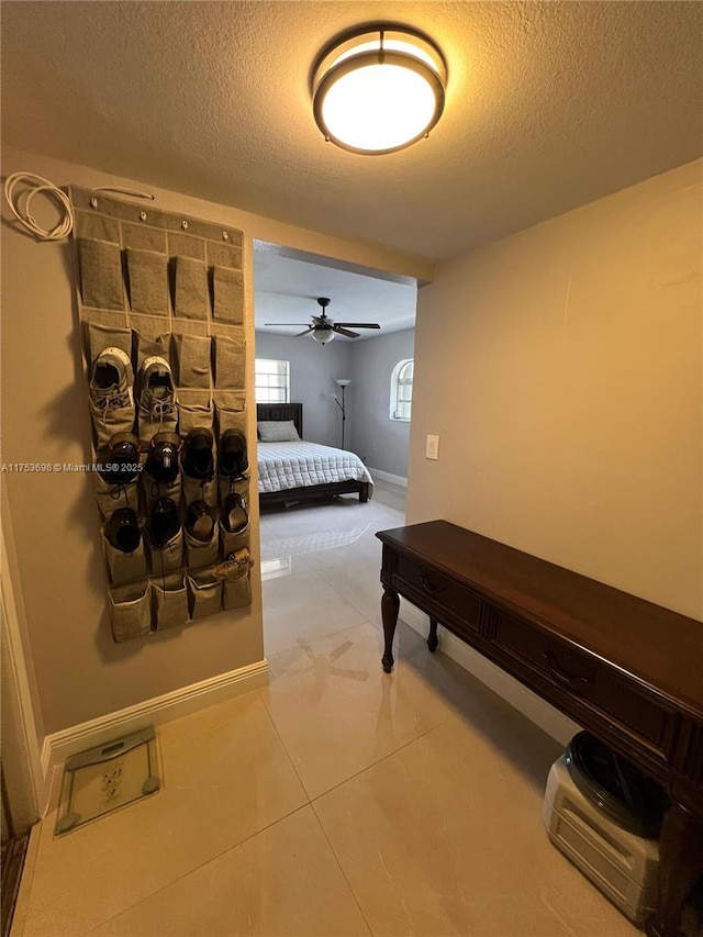 bedroom featuring a textured ceiling and baseboards