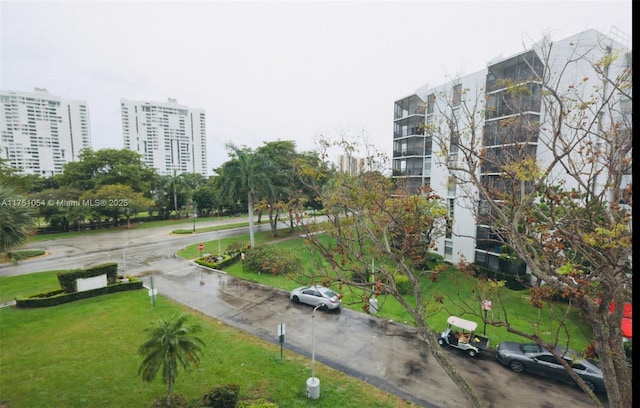 view of home's community with a city view and a lawn