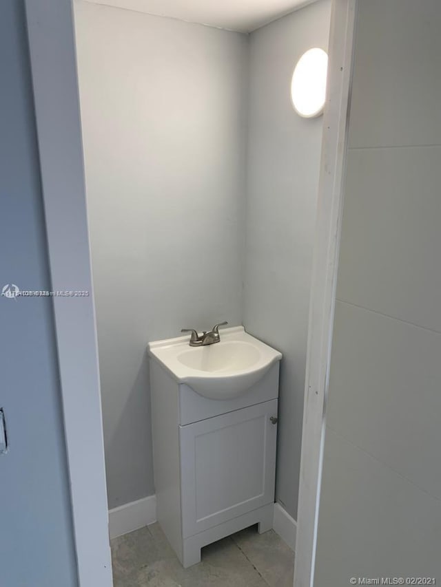 bathroom with vanity and baseboards