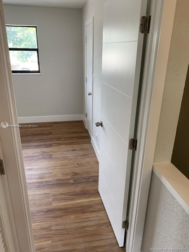 interior space with wood finished floors and baseboards