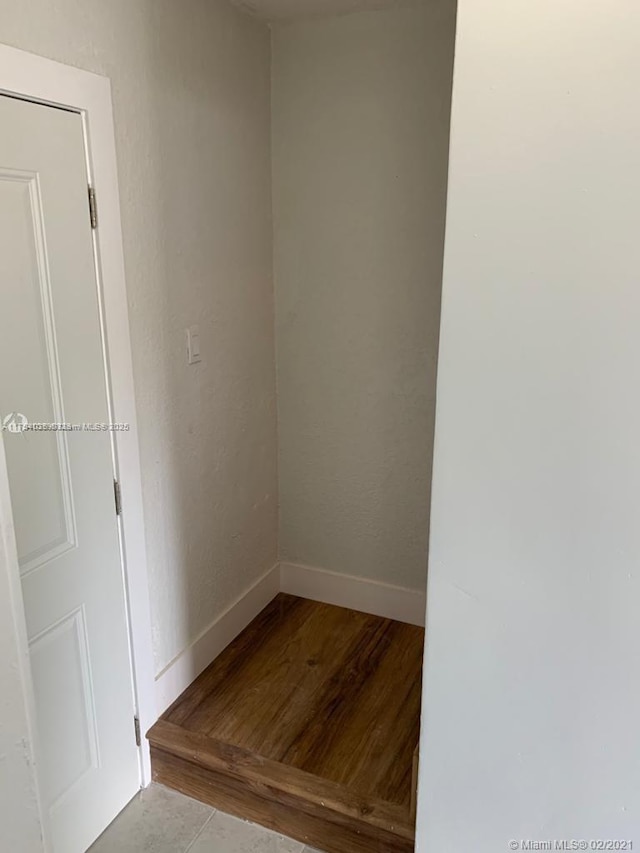 unfurnished room with wood finished floors and baseboards