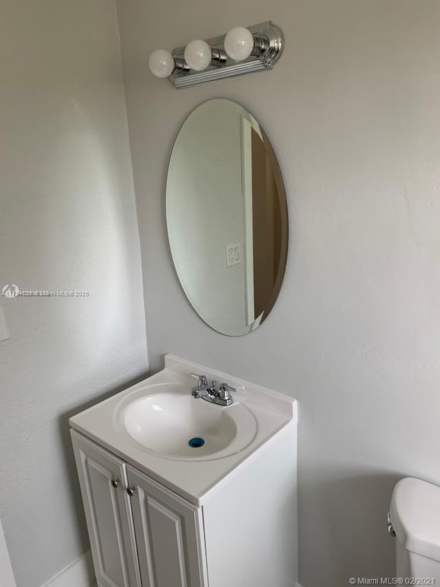 bathroom featuring toilet and vanity