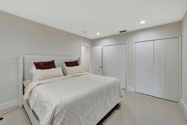 bedroom featuring recessed lighting, visible vents, baseboards, and two closets