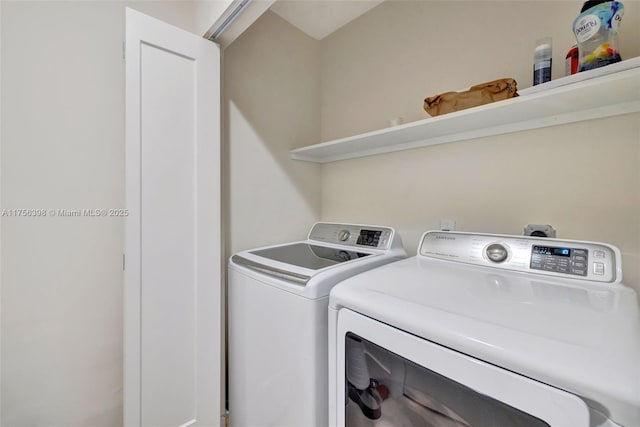 clothes washing area featuring washer and dryer and laundry area