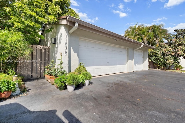 detached garage featuring fence