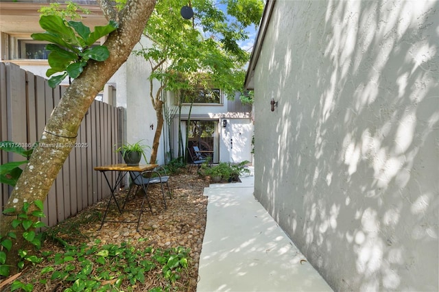 view of home's exterior with a gate and stucco siding